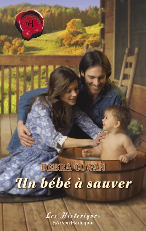 Cover of the book Un bébé à sauver (Harlequin Les Historiques) by Debra Cowan, Harlequin